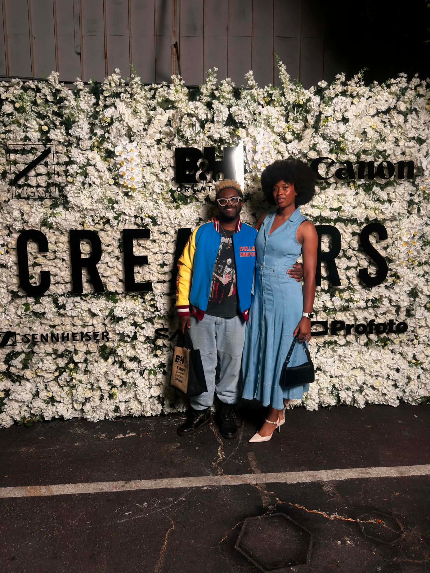 Donye'a and Kyra posing together at a creators event flower wall