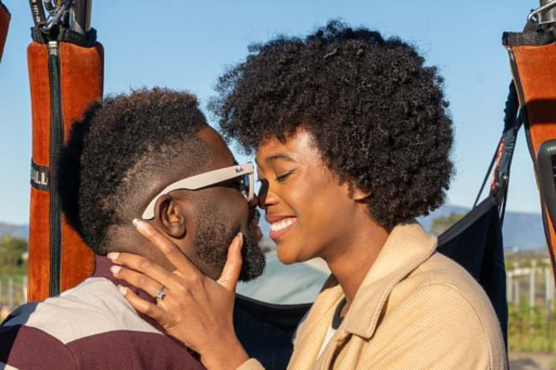 Donye'a and Kyra forehead to forehead in the hot air balloon basket