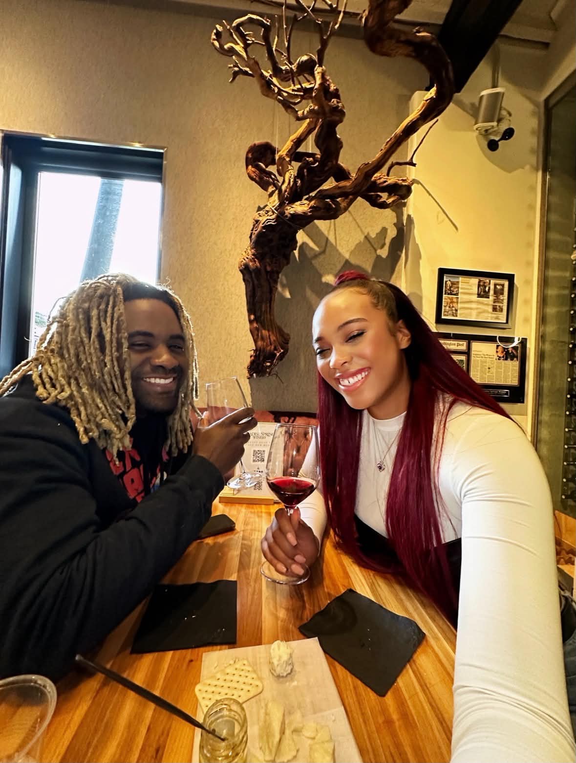 Donye'a and Kyra toasting wine glasses at a tasting room